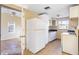 Kitchen featuring white refrigerator, cabinets, countertops, and tile floors at 6317 Georgia Ave, Lakeland, FL 33813