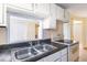 Kitchen features a double stainless steel sink and white cabinets at 6317 Georgia Ave, Lakeland, FL 33813