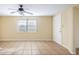 Bright living room with tile flooring, ceiling fan, and a window providing natural light at 6317 Georgia Ave, Lakeland, FL 33813