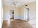 Room featuring beige walls and tile floors with a ceiling fan and two doorways at 6317 Georgia Ave, Lakeland, FL 33813