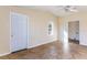 Room featuring beige walls and tile floors with a ceiling fan and multiple windows at 6317 Georgia Ave, Lakeland, FL 33813