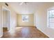 Room featuring beige walls and tile floors with a ceiling fan and multiple windows at 6317 Georgia Ave, Lakeland, FL 33813