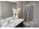 Bathroom with a sink and gray and white stripped shower curtain at 2206 Old Mining Rd, Lakeland, FL 33801