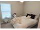 Cozy bedroom with a comfortable bed, soft textures, and natural light from the window at 2206 Old Mining Rd, Lakeland, FL 33801