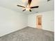 Bedroom features a large window, neutral carpet, and a lighted ceiling fan at 2206 Old Mining Rd, Lakeland, FL 33801