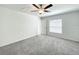 Bright bedroom with neutral walls, plush carpeting, and a modern ceiling fan at 2206 Old Mining Rd, Lakeland, FL 33801