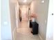 Bright hallway featuring tile flooring, a console table with decor, and fresh neutral paint at 2206 Old Mining Rd, Lakeland, FL 33801
