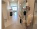 Well-lit hallway with decorative mirrors, accent lighting, and stylish decor leading into the living area at 2206 Old Mining Rd, Lakeland, FL 33801