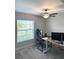 A bright office space featuring modern desks, an ergonomic chair, and a ceiling fan at 2206 Old Mining Rd, Lakeland, FL 33801