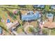 Aerial view of a home with a large backyard and a new roof surrounded by mature trees at 3603 Royal S Ct, Lakeland, FL 33812