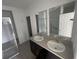 Bathroom featuring double sinks, modern fixtures, and a separate glass-enclosed shower at 145 Andreas St, Winter Haven, FL 33881