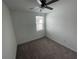 Carpeted bedroom with ceiling fan, light, and a window that provides natural light at 145 Andreas St, Winter Haven, FL 33881