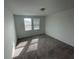 Cozy bedroom filled with light from two windows and neutral carpeting at 145 Andreas St, Winter Haven, FL 33881