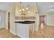 Stylish bar area with a countertop, pendant lighting, and a view into adjacent living spaces at 1612 Cog Hill Dr, Lady Lake, FL 32159