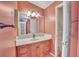 Bathroom vanity with drawers and a cabinet, a mirror, and lighting at 1612 Cog Hill Dr, Lady Lake, FL 32159