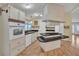 Well-lit kitchen featuring an island cooktop, ample cabinet space, and a cozy breakfast nook at 1612 Cog Hill Dr, Lady Lake, FL 32159