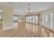 Spacious living room featuring hardwood floors, a dining area, and natural light at 1612 Cog Hill Dr, Lady Lake, FL 32159