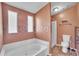 Main bathroom featuring a bathtub, updated tile, and a walk-in shower at 1612 Cog Hill Dr, Lady Lake, FL 32159