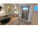 Bathroom featuring a vessel sink, wood countertop and walk-in shower with tile surround at 534 Hawthorne Blvd, Leesburg, FL 34748