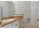 Bathroom featuring large mirror, sink, vanity, decorative wall decals, and fixtures at 131 Vine Dr, Davenport, FL 33837
