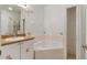 Bathroom with large tub, vanity with flower decals, and open shelving at 131 Vine Dr, Davenport, FL 33837