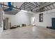 Spacious garage with storage racks, water heater, and door leading to the interior of the home at 131 Vine Dr, Davenport, FL 33837