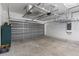 Spacious garage featuring a grey door, storage racks, and access to the interior of the home at 131 Vine Dr, Davenport, FL 33837