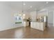 Kitchen with stainless steel appliances, a center island with sink and granite counters and cream cabinets at 131 Vine Dr, Davenport, FL 33837