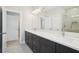 Modern bathroom features dual sinks, a large mirror and a glass enclosed shower at 2304 Depauw Ave, Orlando, FL 32804