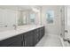 Modern bathroom features dual sinks, a large mirror and a glass enclosed shower at 2304 Depauw Ave, Orlando, FL 32804