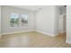 Bright bedroom featuring large windows, light wood flooring, and neutral walls at 2304 Depauw Ave, Orlando, FL 32804