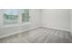 Bedroom featuring soft carpet and natural light from the large windows at 2304 Depauw Ave, Orlando, FL 32804