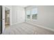 Bright bedroom with neutral walls, plush carpet, closet and natural light from windows at 2304 Depauw Ave, Orlando, FL 32804