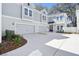 Beautiful gray home with a three-car garage, elegant landscaping, and inviting curb appeal at 2304 Depauw Ave, Orlando, FL 32804