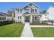 Charming two-story home featuring a well-manicured lawn, a covered porch, and craftsman-style architecture at 2304 Depauw Ave, Orlando, FL 32804