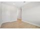 Hallway leading to a room with light wood flooring and neutral walls at 2304 Depauw Ave, Orlando, FL 32804