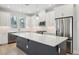 Open-concept kitchen with a large island, white cabinets, stainless steel appliances, and sleek countertops at 2304 Depauw Ave, Orlando, FL 32804