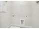 Functional laundry area with hookups and storage shelving for convenience at 2304 Depauw Ave, Orlando, FL 32804