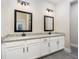 Bathroom featuring double sinks, granite counters, and modern black fixtures at 7709 Somersworth Dr, Kissimmee, FL 34747