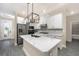 Modern kitchen featuring stainless steel appliances, a large island, and white cabinetry at 7709 Somersworth Dr, Kissimmee, FL 34747