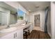Well-lit bathroom featuring dual sinks, a vanity area, and a separate shower and toilet area with a curtain at 1600 Ellesmere Ave, Haines City, FL 33844