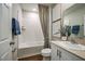 Clean bathroom featuring a shower-tub combo, white vanity, neutral countertops, framed art, and wood-look flooring at 1600 Ellesmere Ave, Haines City, FL 33844
