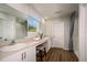 Bathroom featuring dual sinks, a vanity area, separate shower, toilet area, and hardwood flooring at 1600 Ellesmere Ave, Haines City, FL 33844