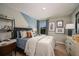 Comfortable bedroom with gray walls, study space, and an assortment of decorative artwork at 1600 Ellesmere Ave, Haines City, FL 33844