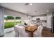 Dining area with a kitchen view, a wooden table with seating for six, and natural light from sliding glass doors at 1600 Ellesmere Ave, Haines City, FL 33844