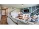 Comfortable living room with a large sectional sofa, decorative wall accents, and a staircase leading to the upper level at 1600 Ellesmere Ave, Haines City, FL 33844