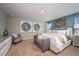 Inviting primary bedroom with a decorative wall, king bed, stylish bench, dresser, and attractive artwork at 1600 Ellesmere Ave, Haines City, FL 33844