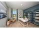 Office with a large desk, chair, modern shelving, bright light, and large painting for a creative workspace at 1600 Ellesmere Ave, Haines City, FL 33844