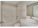 Bathroom with shower-tub combo, single sink, and white cabinets at 1604 Ellesmere Ave, Haines City, FL 33844