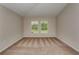 Bedroom with plush carpeting and two windows offering a view of the outdoors at 1604 Ellesmere Ave, Haines City, FL 33844
